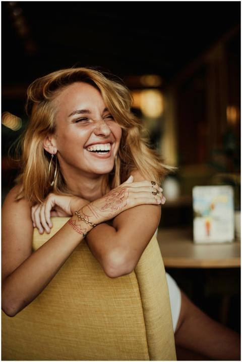 Smiling woman enjoying a carefree moment indoors i