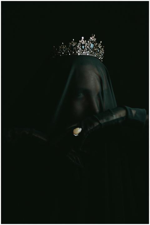 Ethereal portrait of a woman in darkness wearing a