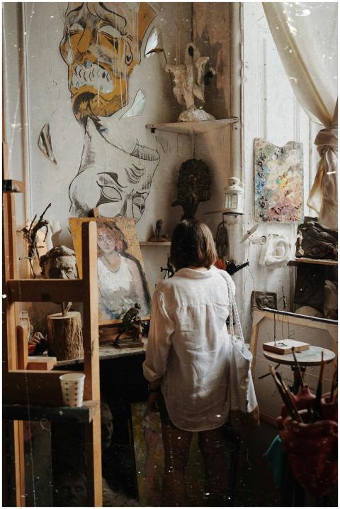 Woman standing in an art studio surrounded by crea