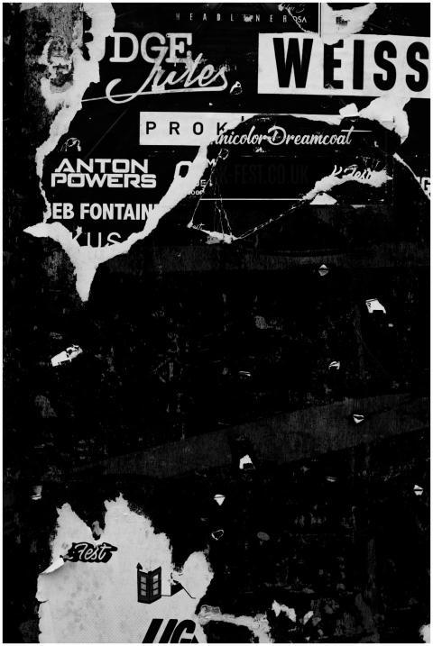 Black and white photo of torn street posters on a