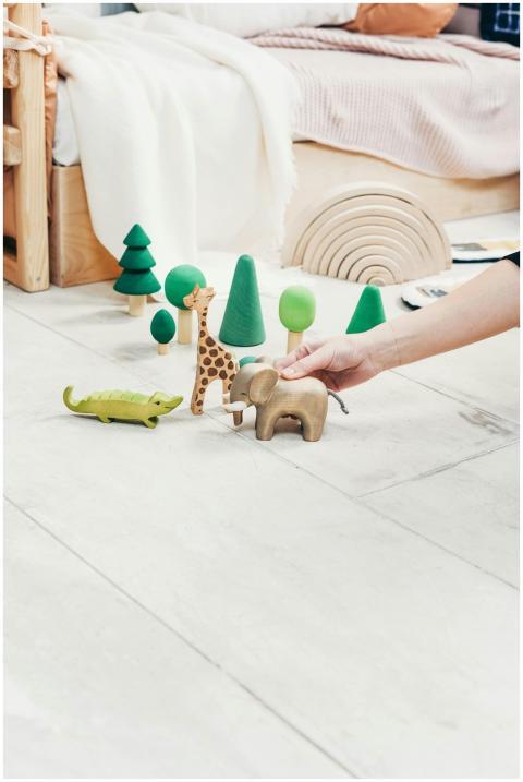 A playful indoor scene featuring a child's hand en