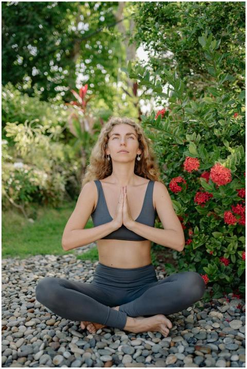 A woman practices yoga meditation in a tranquil ou