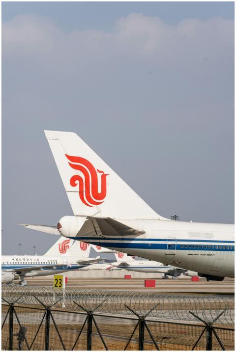 Airport scene featuring multiple airplanes parked