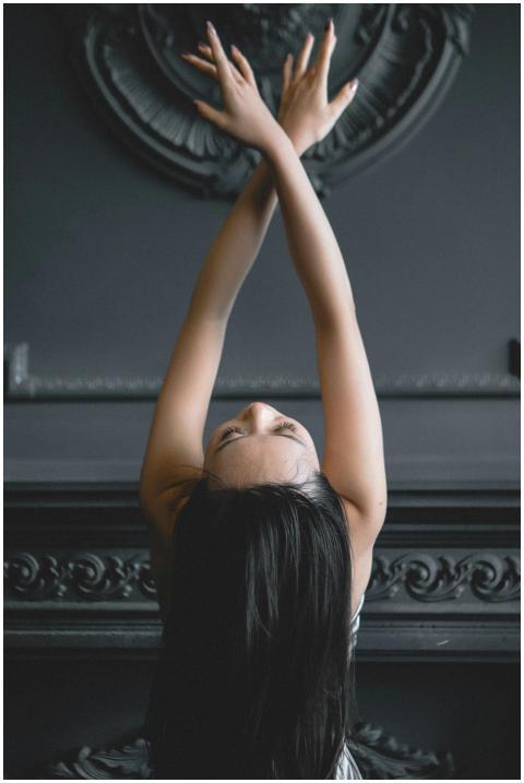 A young woman elegantly posing in a contemporary d