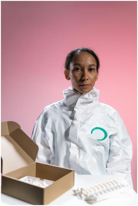 Healthcare worker in PPE with vaccine supplies in