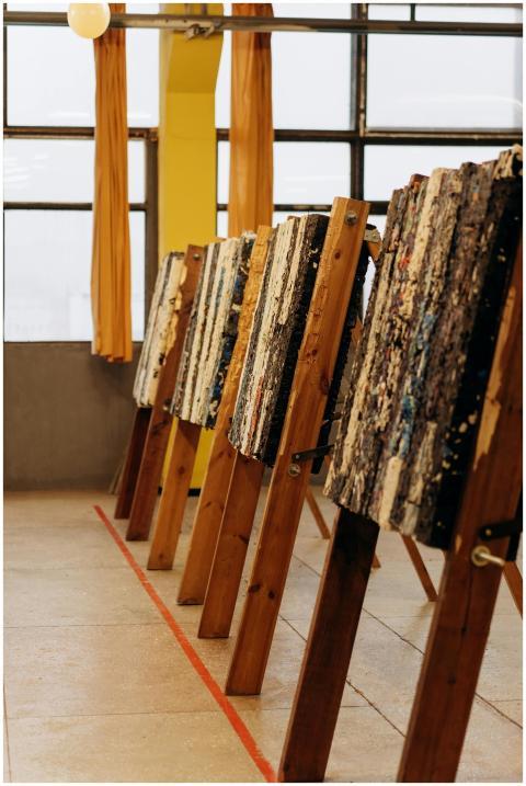 A line of archery targets indoors, set against a w