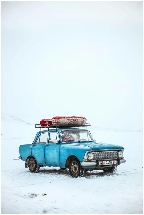 Classic blue car in snowy winter scene, Ak-Talaa D