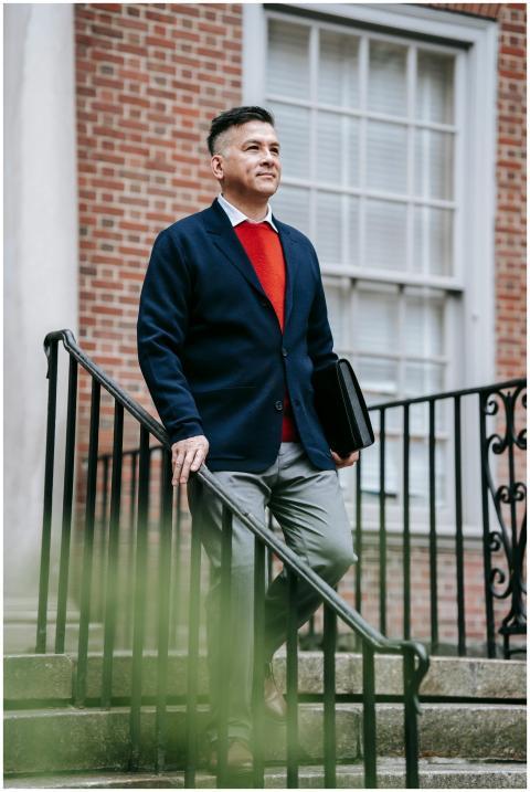 Confident man in a fashionable suit holding a brie