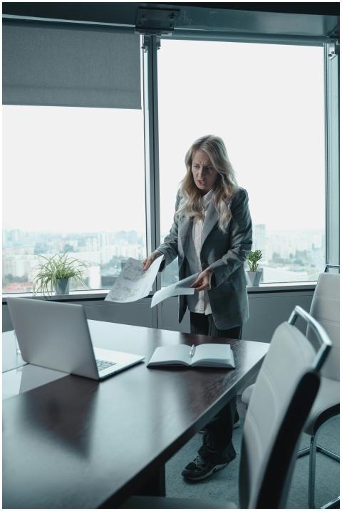 Businesswoman reviewing documents at an office win