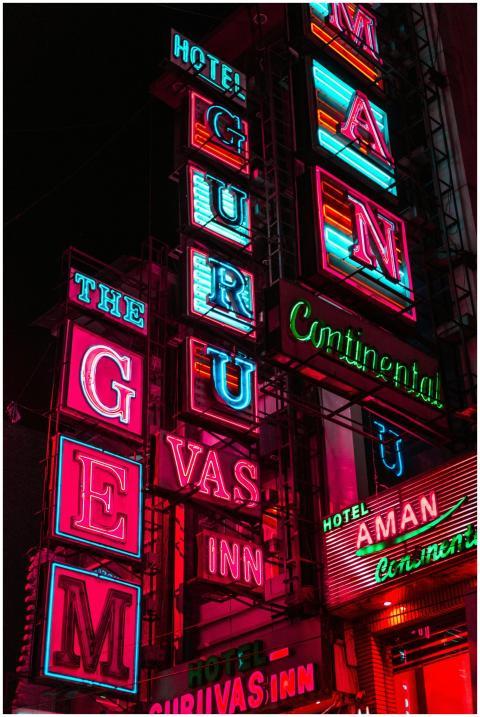 Dynamic neon signs illuminate the night, advertisi