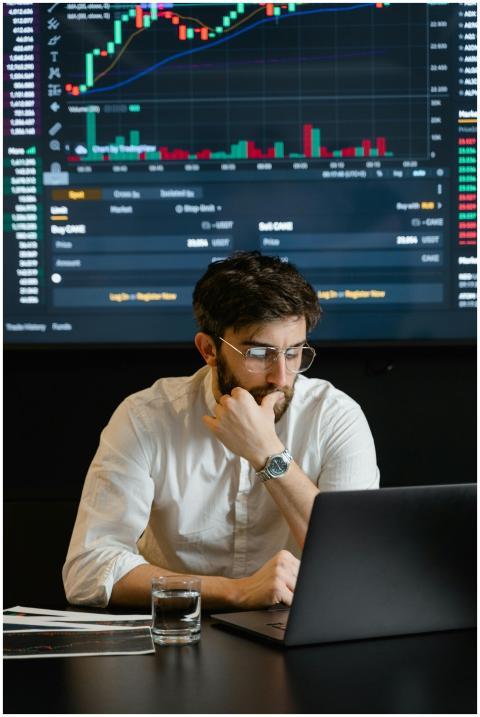 Pensive businessman with a beard analyzing stock m