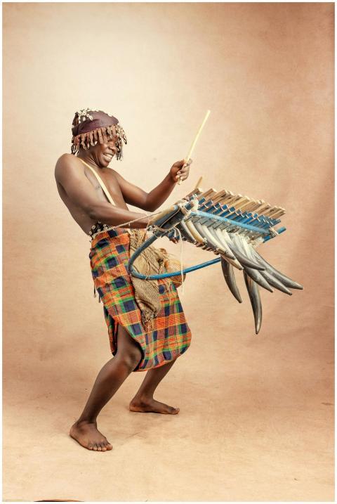 African man playing a unique traditional musical i