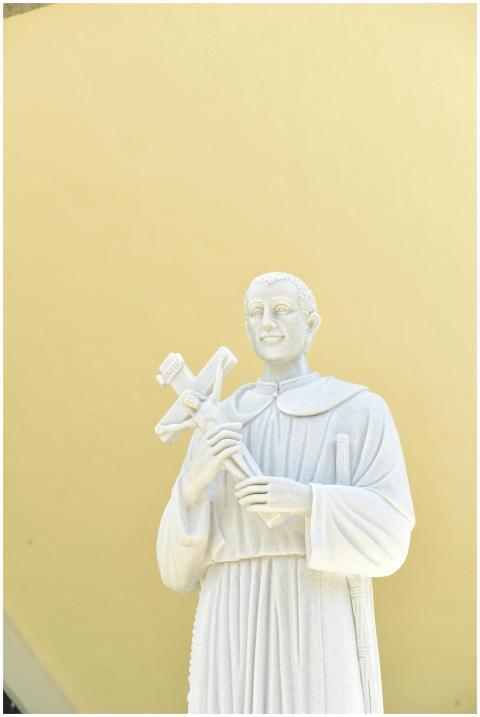 A close-up view of a white stone statue of a saint