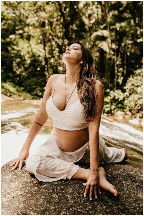 Pregnant woman practicing yoga and meditation on a