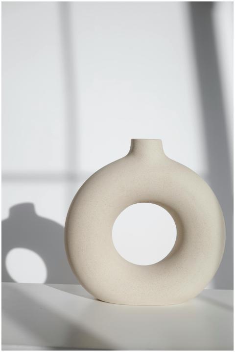 Elegant circular ceramic vase casting gentle shado