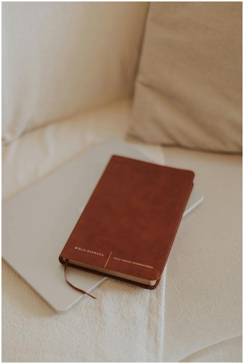 Brown leather Bible placed on a sofa, perfect for