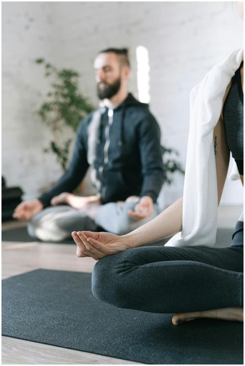 Adults practicing yoga indoors, focusing on mindfu