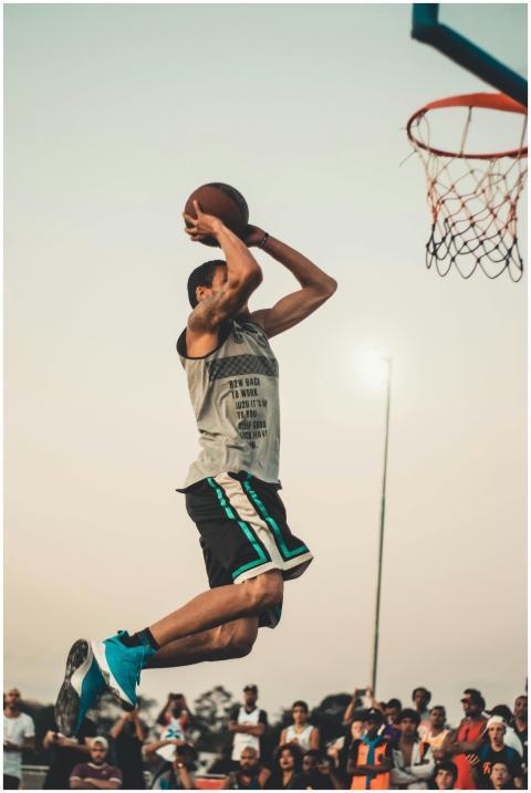 Athlete executing a powerful dunk during an intens