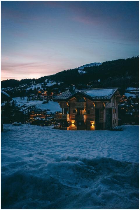 Enchanting view of a snow-covered cabin at dusk in