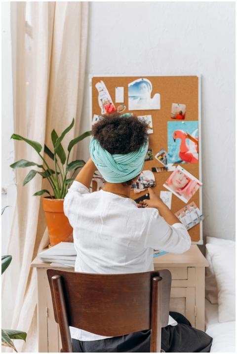 A woman sitting at a desk, engaging with her creat