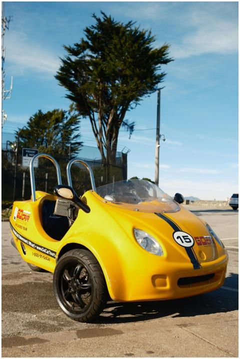 A bright yellow GoCar parked outdoors in Los Angel