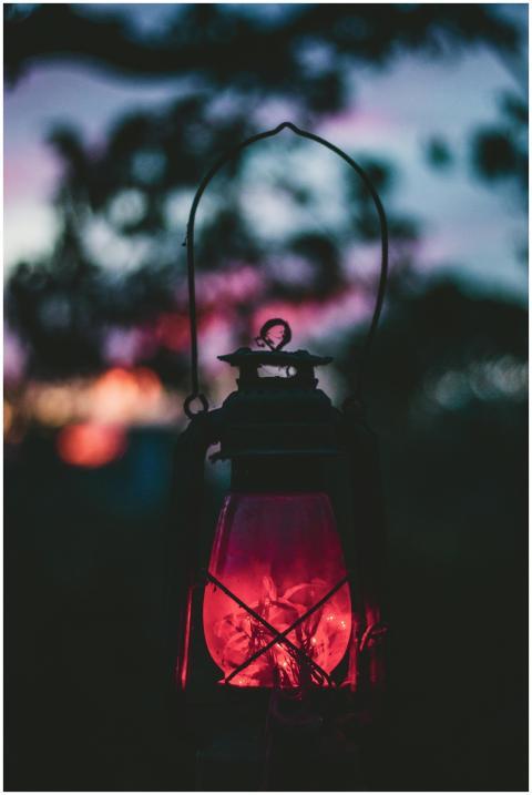 A classic vintage lantern emits a warm glow agains