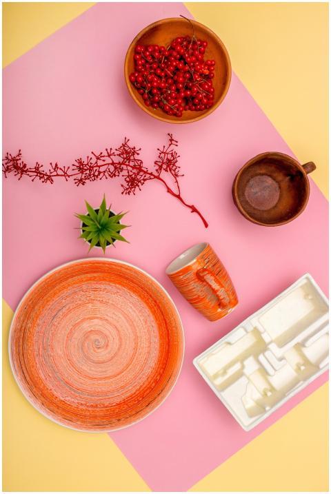 Artistic flat lay of ceramics and berries on a vib