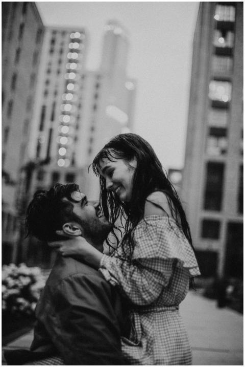 A romantic black and white photo of a couple embra