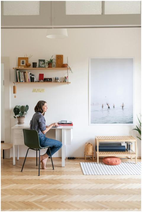 Woman working at a desk in a stylish, minimalist h