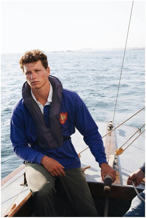 A young man enjoying a peaceful sailing trip off t