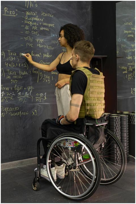 Teacher instructing student in a wheelchair at bla