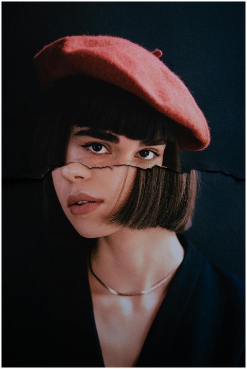 Striking studio portrait of a young woman with a r
