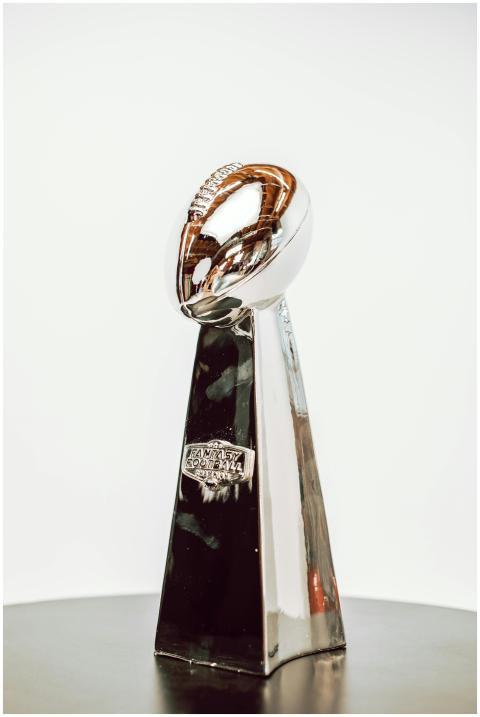 Sleek silver football trophy with shiny finish, pe