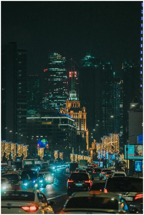 Illuminated urban street scene at night with heavy