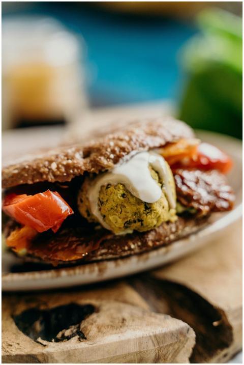 Delicious vegan falafel sandwich with fresh tomato