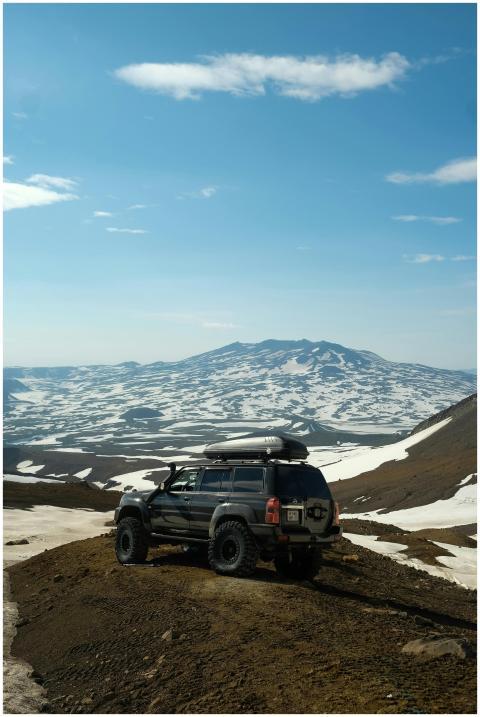 An off-road SUV navigating snowy mountain landscap