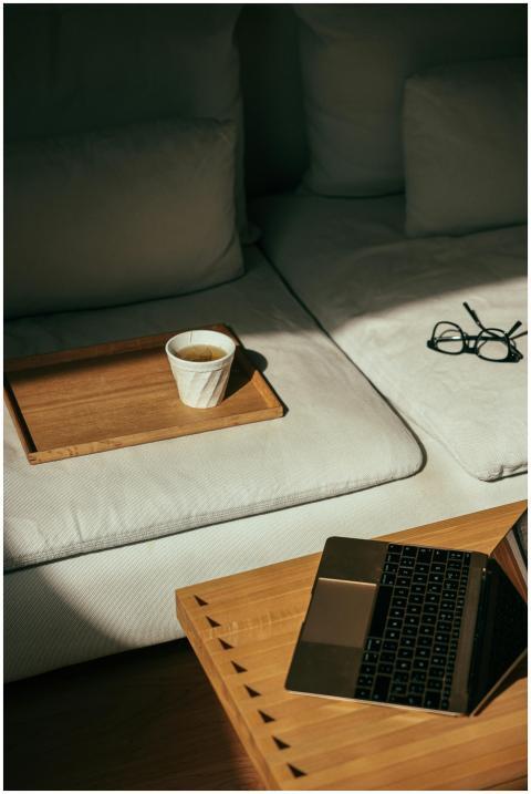 Modern home office corner with laptop, coffee, and