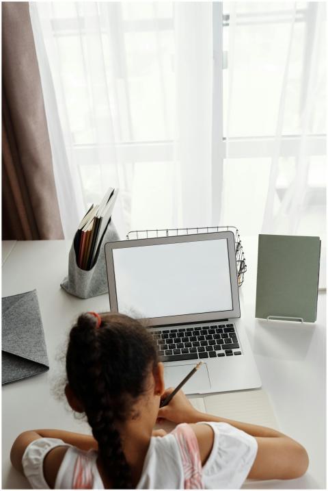 A young girl focuses on distance learning with her