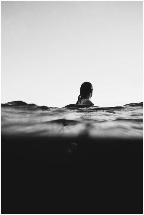 Artistic black and white photo of a woman swimming