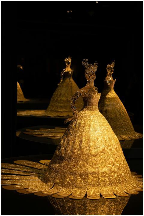 A beautifully lit golden figurine in a dark settin