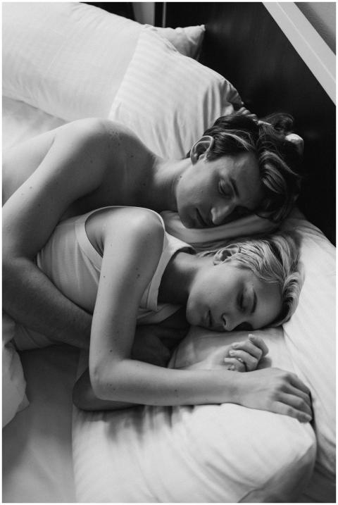 Intimate grayscale photo of a couple embracing whi