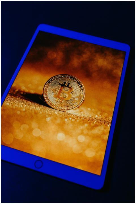 A golden Bitcoin coin displayed digitally on a tab