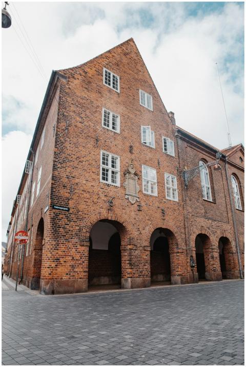 A vintage brick building with arched windows and a