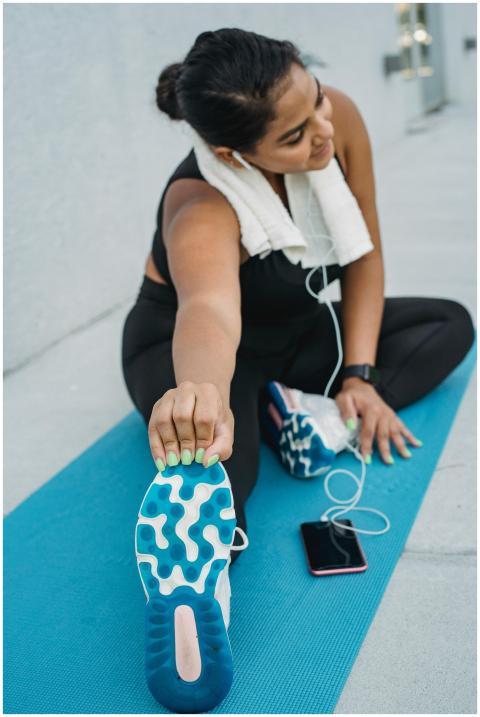 Woman enjoying a post-yoga exercise stretch on a m