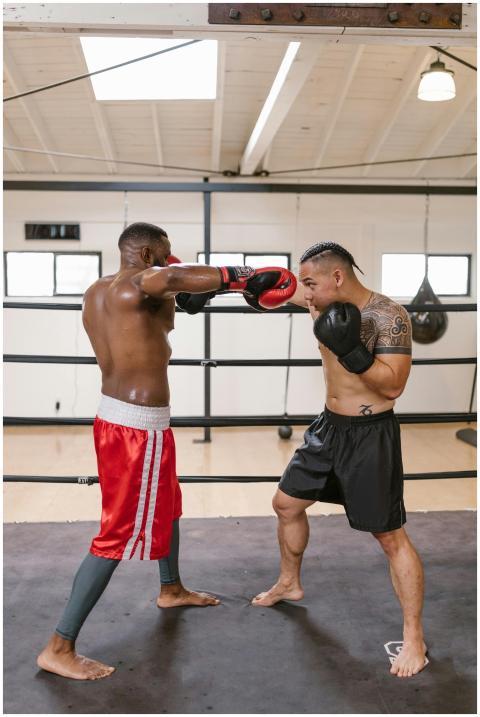 Two men sparring in a boxing ring during an intens