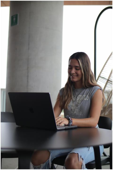Young woman using a laptop in a modern indoor sett