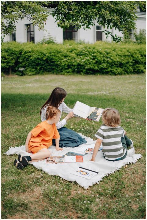 Mother and children enjoy a reading session on a p
