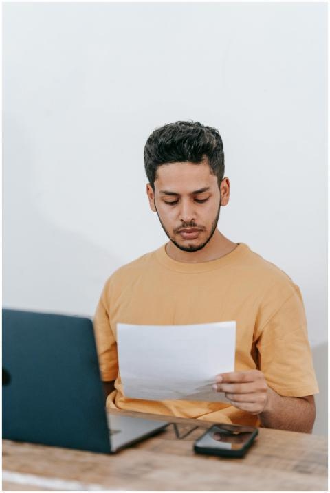 Serious young bearded Hispanic businessman in casu