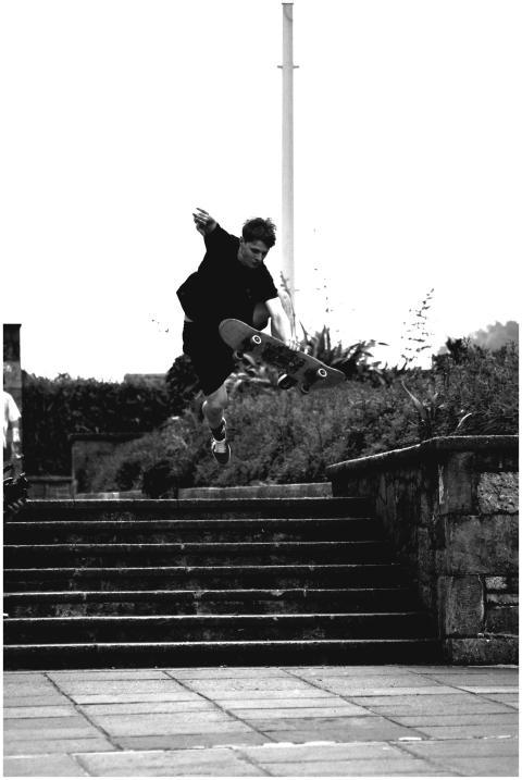 Dynamic black and white shot of a skateboarder jum