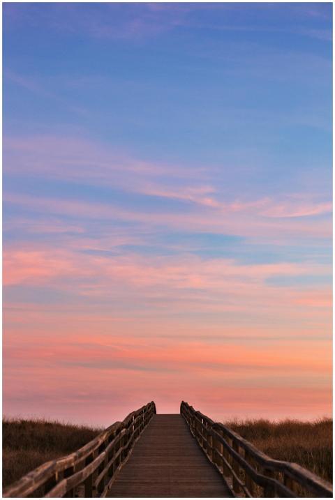 Captivating sunset over a coastal boardwalk leadin